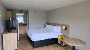 a hotel room with a bed and a television at Days Inn by Wyndham Paducah I-24 Exit 4 in Paducah