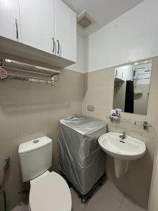 a small bathroom with a toilet and a sink at MDM Staycation by SMDC in Manila