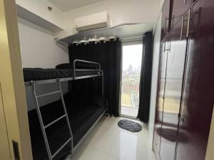 a small room with a bunk bed and a window at MDM Staycation by SMDC in Manila