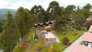 an aerial view of a house with a playground at Pousada das Pedras in Monte Verde