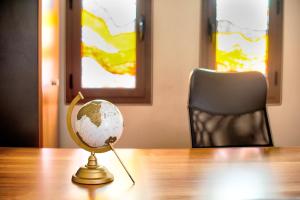 a small globe on a table with a chair at Spata sunrise house in Spata