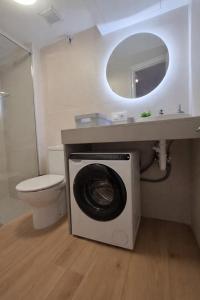 a bathroom with a washing machine under a sink at Apartamento Estartit Argonavis in L'Estartit +27 photos
