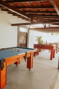 a pool table with balls on it in a room at Pousada Piratininga in Niterói