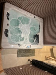 a plastic tub with green liquid in it on an airplane at Duplex with Jacuzzi - Grand place Arras in Arras +27 photos