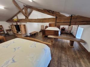 a bedroom with a bed and a living room at Gîte de La Rev'rie in Montalembert