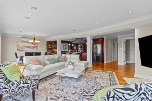 a living room with a white couch and a rug at Forest House QV Lake View Parking in St. John's