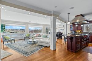 a kitchen and living room with a couch and a table at Forest House QV Lake View Parking in St. John's
