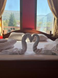 two swans making a heart on a bed at Hotel Paradise in Kyustendil