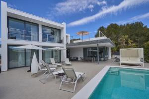 a villa with a swimming pool and a house at Can Anara in Cala Llena
