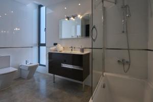 a bathroom with a sink and a shower and a toilet at Can Anara in Cala Llena +29 photos