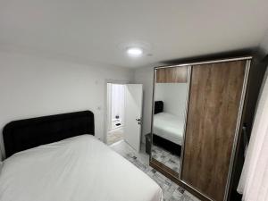 a small bedroom with a bed and a mirror at BR Konaklama in Göztepe +11 photos