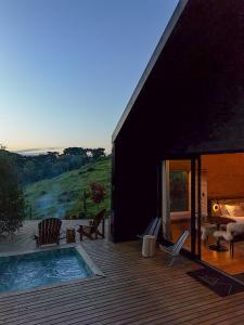 a house with a swimming pool on a wooden deck at Vale Sagrado in Urubici