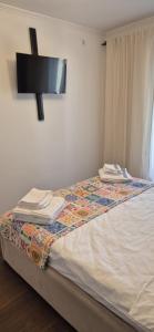 a bedroom with a bed with a tv on the wall at Cosmo Iris in Ştefăneştii de Sus +8 photos