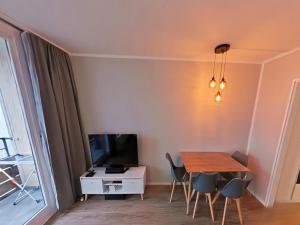a dining room with a table and a tv at Appartement Serges mit Pool und Sauna in Freyung in Freyung
