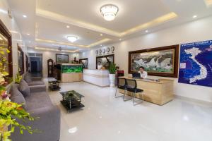 a lobby with a woman sitting at a desk at Luxury Airport Hotel Travel in Sóc Sơn