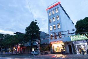 a tall building on the corner of a street at Luxury Airport Hotel Travel in Sóc Sơn