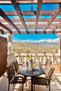 a table on a balcony with a view of the desert at Cap Esterel - Duplex avec 2 terrasses dont une tropezienne, piscines et loisirs in Saint-Raphaël