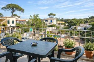 a table and chairs on a balcony with a view at Variopinto Home in Ischia Town