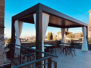 a patio with tables and chairs on a roof at Ariccia Luxury House camere di charme con spa privata per soggiorni romantici in Ariccia