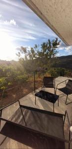 two beds sitting on top of a patio with a view at Malu in Pinhal do Douro