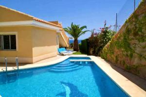 a swimming pool in front of a house at Casa Elletofft in Puerto de Mazarrón