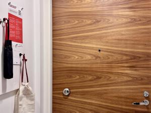 a room with a wooden door with a wooden floor at Borg Areena - Stylish Studio Apt For 3 in Tampere