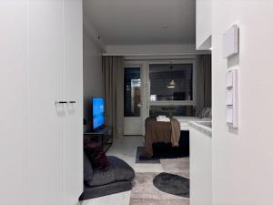a room with a bedroom with a bed and a television at Borg Areena - Stylish Studio Apt For 3 in Tampere +1 photo