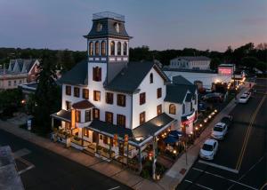 a large white building with a clock tower on top at The Washington House Hotel & Restaurant in Sellersville
