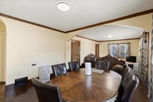 a dining room with a table and leather chairs at College Area 3BR in Grand Rapids