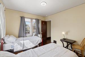 a hotel room with two beds and a window at College Area 3BR in Grand Rapids +16 photos