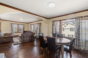 a living room with a table and chairs at College Area 3BR in Grand Rapids