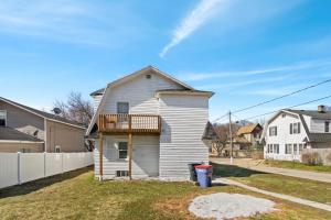 a house with a balcony on the side of it at College Area 3BR in Grand Rapids