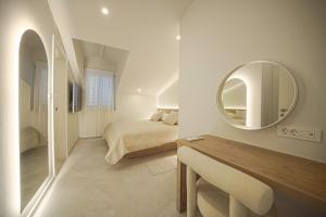 a white bedroom with a bed and a mirror at Apartments Bianca Vodice in Vodice +94 photos
