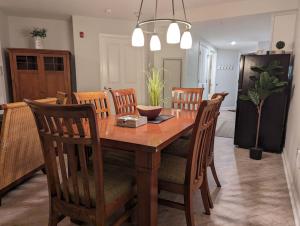 a dining room with a wooden table and chairs at Premium New 1bd Sunset balcony 3rd flr in Vernon Township