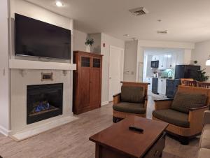 a living room with a fireplace with a flat screen tv at Premium New 1bd Sunset balcony 3rd flr in Vernon Township