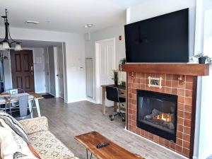 a living room with a fireplace with a flat screen tv at Renovated Chic Premium 1 bdrm in Vernon Township