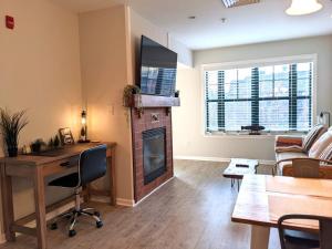 a living room with a desk and a fireplace at Renovated Chic Premium 1 bdrm in Vernon Township