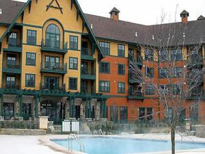 a large building with a swimming pool in front of it at Renovated Chic Premium 1 bdrm in Vernon Township