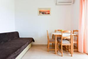 Zimmer mit einem Bett, einem Tisch und Stühlen in der Unterkunft Apartment Ljubac 4 in Ljubač