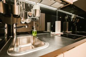 a kitchen counter with a sink and utensils at Karlo Main Square Apartments in Zagreb +93 photos