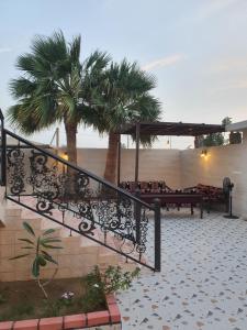 a staircase leading to a restaurant with palm trees at Villa Ar Rayis Beach in Rayyis