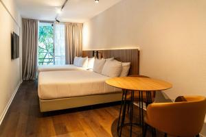 a hotel room with a bed and a table at City Express Plus by Marriott Buenos Aires Palermo in Buenos Aires +70 photos
