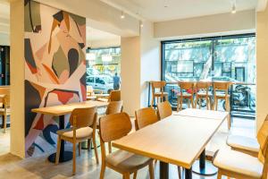 a restaurant with tables and chairs and a large window at City Express Plus by Marriott Buenos Aires Palermo in Buenos Aires