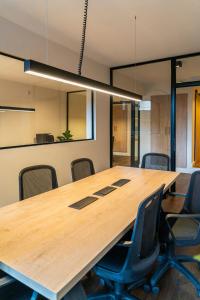 a conference room with a large wooden table and chairs at City Express Plus by Marriott Buenos Aires Palermo in Buenos Aires