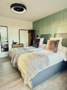 a bedroom with two beds and a mirror at United Home B&B in Manchester