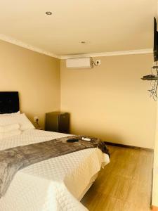 a hotel room with two beds and a fan at Rainow guest house in Burgersfort