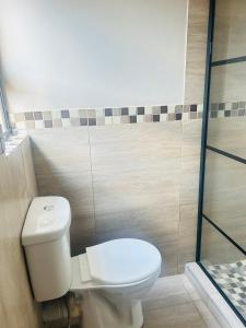 a bathroom with a toilet and a shower at Rainow guest house in Burgersfort