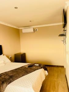 a hotel room with two beds and a fan at Rainow guest house in Burgersfort