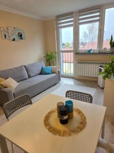a living room with a table and a couch at GreatHome Apartament in Zator