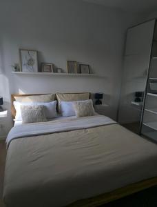 a bedroom with a large bed with white sheets and pillows at Burg & Tal Panorama in Riedenburg